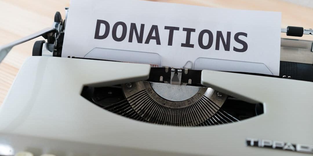 a close up of a typewriter with a donation sign on it