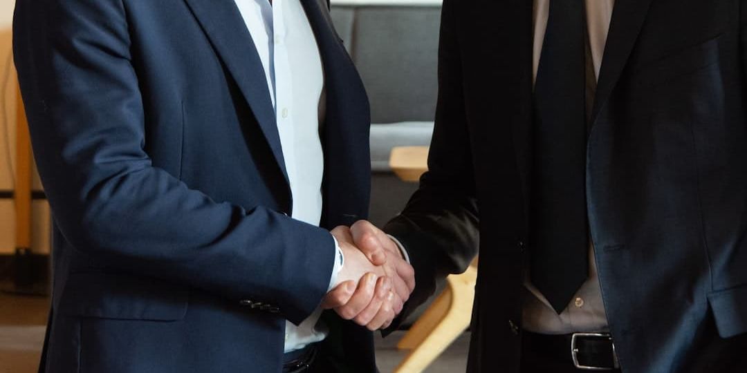 Two business partners shaking hands in agreement.
