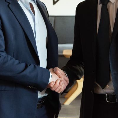 Two business partners shaking hands in agreement.