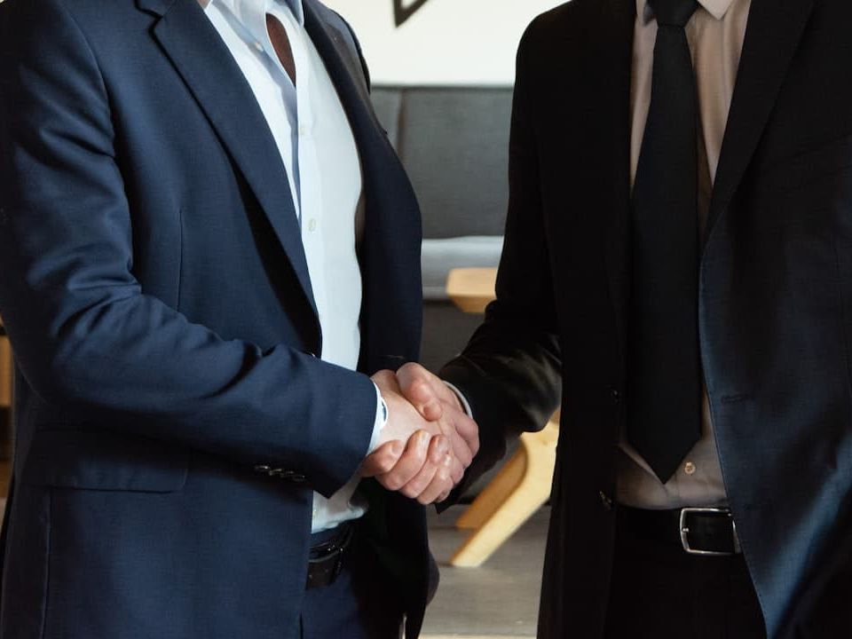 Two business partners shaking hands in agreement.